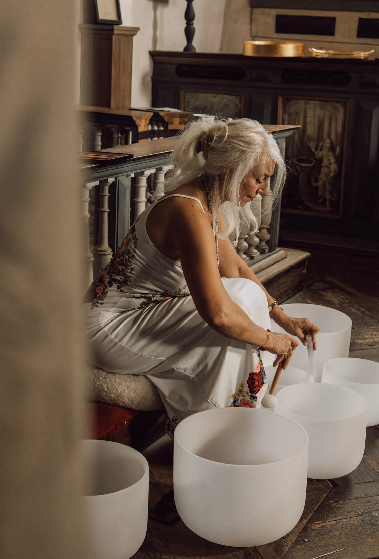 Aurelina preparing the crystal singing bowls inside Wenngarn Castle